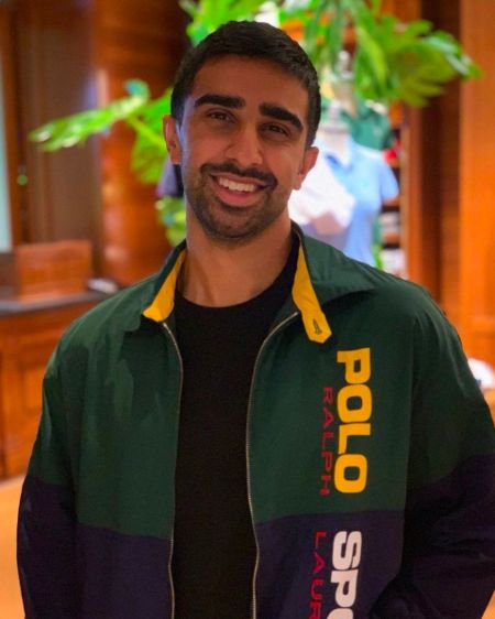 Vikkstar poses for a picture in a green jacket.